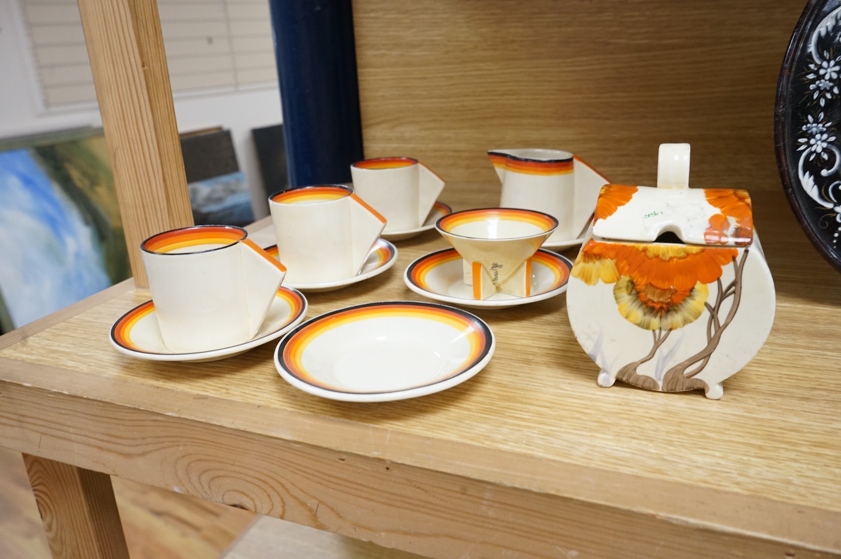 An Art Deco Clarice Cliff Bizarre part coffee set and a similar Rhodanthe-pattern preserve pot and cover, largest 11cm high